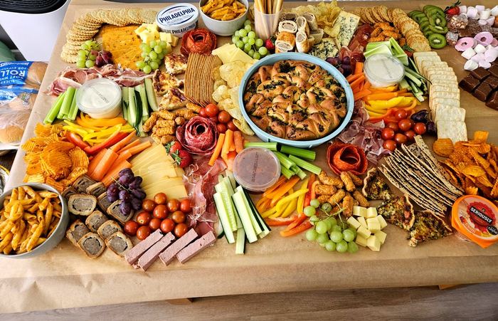 Grazing board with cheese, cured meats, crackers and fresh bread